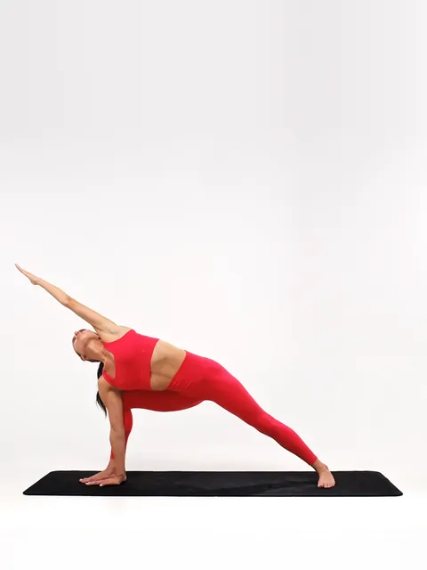 A woman in a side-angle stretch on a mat