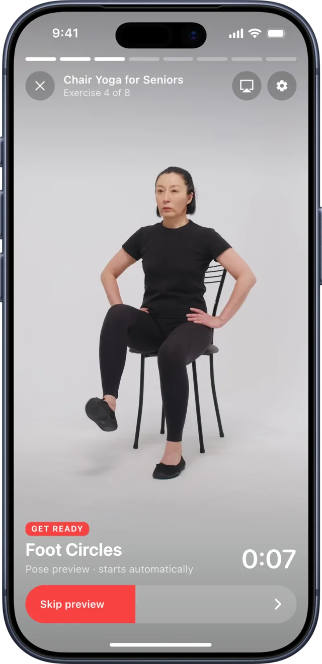 The Slimly player previewing the next chair yoga exercise, Foot Circles: a woman lifts one foot while sitting on a chair